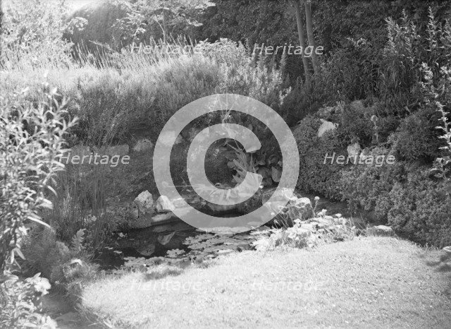 Pond in a garden, c1935. Creator: Kirk & Sons of Cowes.