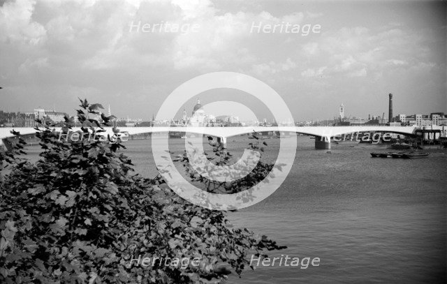 A view eastwards along the River Thames to Waterloo Bridge and the City of London, c1945-c1965 Artist: SW Rawlings