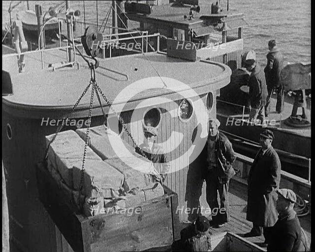 Male Civilians Unloading Illegal Cargo from a Boat, 1932. Creator: British Pathe Ltd.
