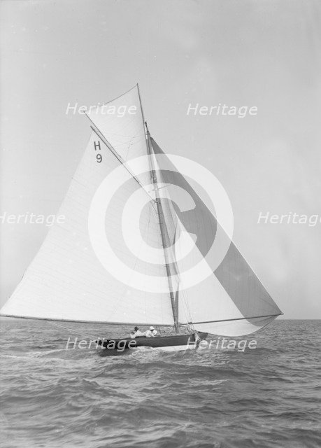 The 8 Metre class 'Termagent' (H9) sailing with spinnaker, 1911. Creator: Kirk & Sons of Cowes.