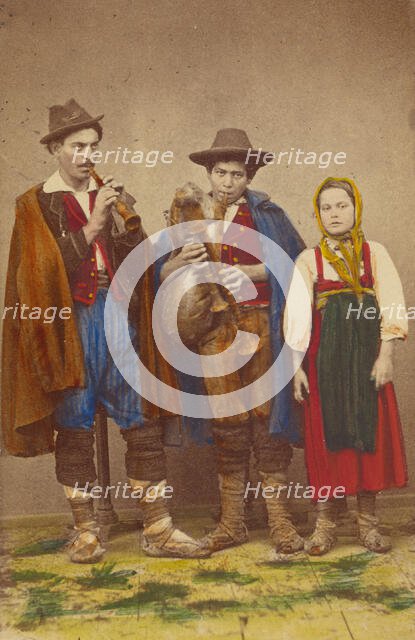 Three Italian peasants standing: two men playing wind instruments, a girl next to them, 1865-1875. Creator: Giorgio Conrad.