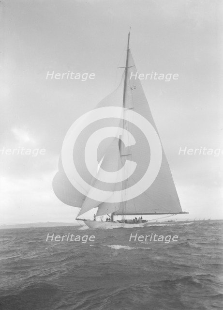 The 23-metre cutter 'Astra' sailing with spinnaker, 1932. Creator: Kirk & Sons of Cowes.