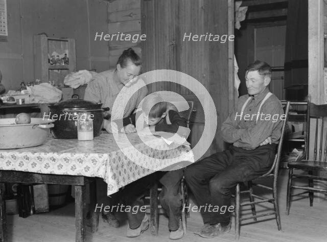 The Wardlow family in their dugout basement home on Sunday, Dead Ox Flat, Oregon, 1939. Creator: Dorothea Lange.
