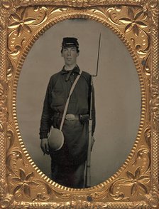 Civil War Union Soldier with Rifle and Canteen, in Studio, 1861-65. Creator: Unknown.