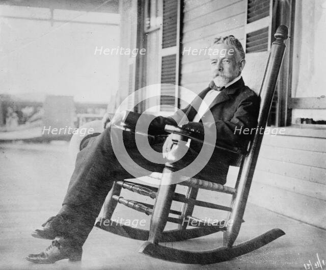 Sen. H.C. Lodge in rocker on porch, 1910. Creator: Bain News Service.