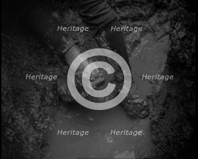 The Legs and Boots of a Male French Soldiers as He is Standing in a Water-Logged Muddy Trench, 1939. Creator: British Pathe Ltd.