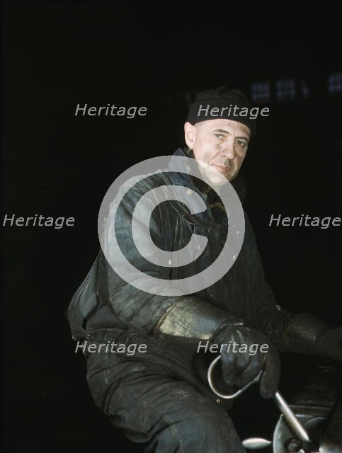 A worker in the roundhouse at the C & NW RR., Proviso yard, Chicago, Ill., 1942. Creator: Jack Delano.