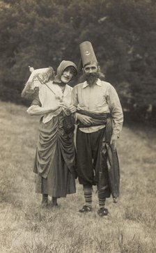 Harry Smallwood and another man stand in a field, one in drag and the other..., 1925. Creator: Unknown.