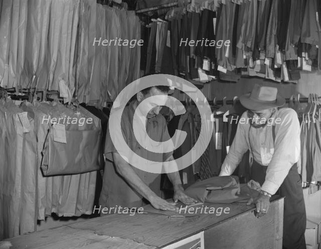 A tailor in Frank's cleaning and pressing establishment altering..., Washington, D.C., 1942. Creator: Gordon Parks.