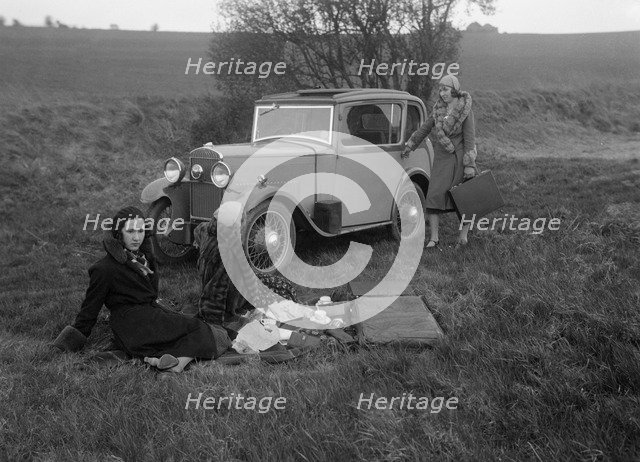 Three women having a picnic during a road test of a Triumph Scorpion, 1931. Artist: Bill Brunell.