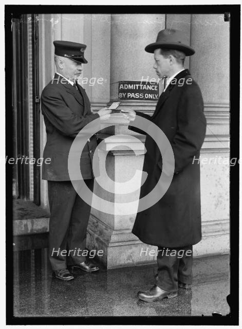 Examining pass at State Department Building, between 1913 and 1918. Creator: Harris & Ewing.