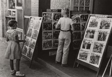 Children looking at posters in front of movie, Saturday, Steele, Missouri,  1938-08. Creator: Russell Lee.