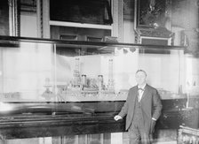 Daniels, Josephus, Secretary of The Navy, 1913-1921. with Model of U.S.S. New York, 1914. Creator: Harris & Ewing.