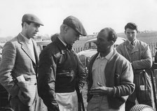 Mike Hawthorn and Stirling Moss chatting at Goodwood 1956. Creator: Unknown.