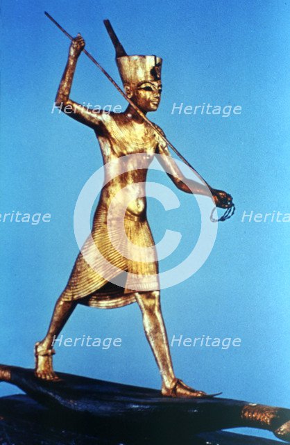 Gold figure of King Tutankhamun standing on a reed boat and spearing fish, 14th century BC. Artist: Unknown
