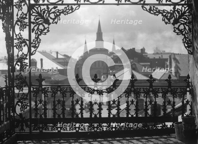 A vista through iron lace, New Orleans, between 1920 and 1926. Creator: Arnold Genthe.