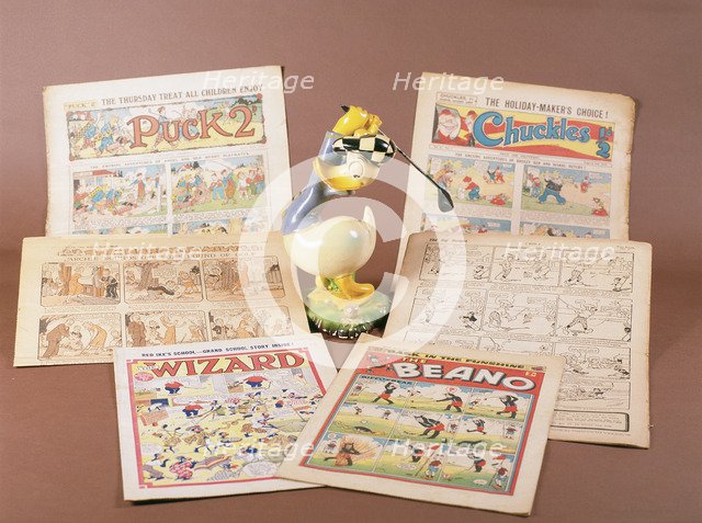 Children's comics with golfing theme, and Donald Duck figurine, c1950s-1960s. Artist: Unknown