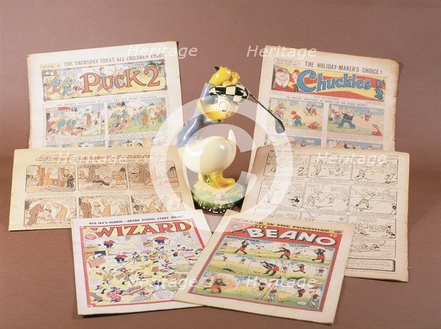 Children's comics with golfing theme, and Donald Duck figurine, c1950s-1960s. Artist: Unknown