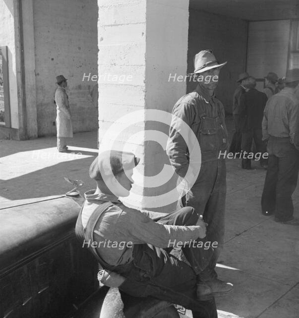 Pea pickers waiting at FSA office for issue of surplus commodities, Calipatria, California, 1939. Creator: Dorothea Lange.