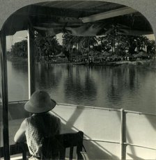 'On a Steamer on the Lualaba River, Belgian Congo - A Native Village at the Water's Edge', c1930s. Creator: Unknown.