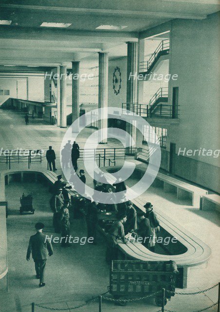 Customs officers examining passengers' baggage at Le Bourget Airport, Paris, 1937. Artist: Unknown.