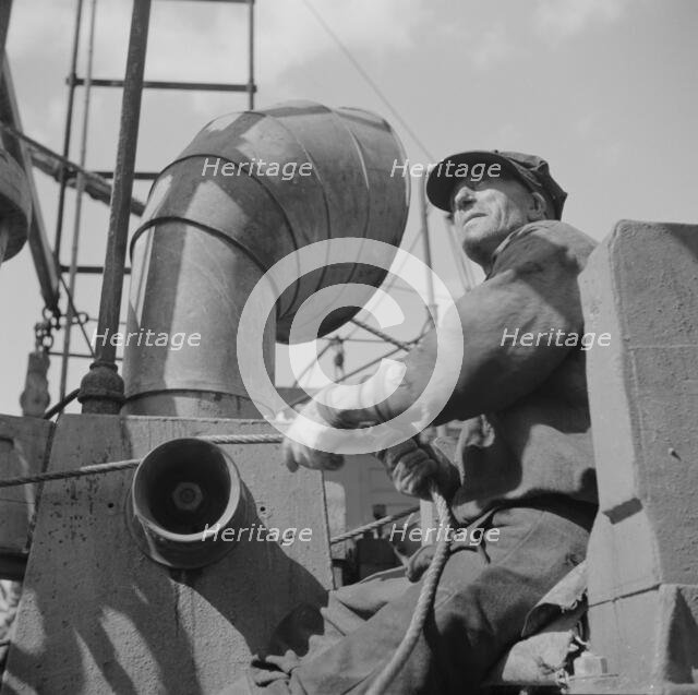 A hoister unloading fish at Fulton fish market, New York, 1943. Creator: Gordon Parks.