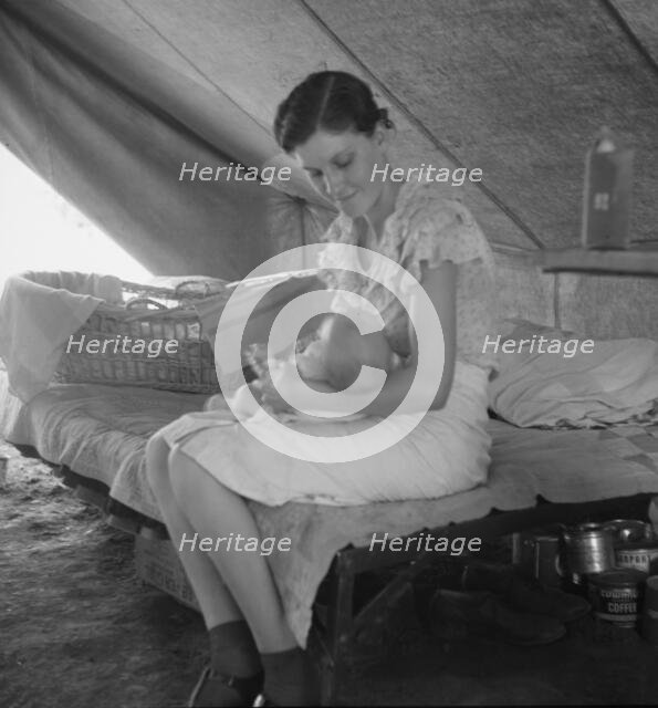 Young migrant mother with six weeks old baby born in a hospital, near Westley, CA, 1939. Creator: Dorothea Lange.