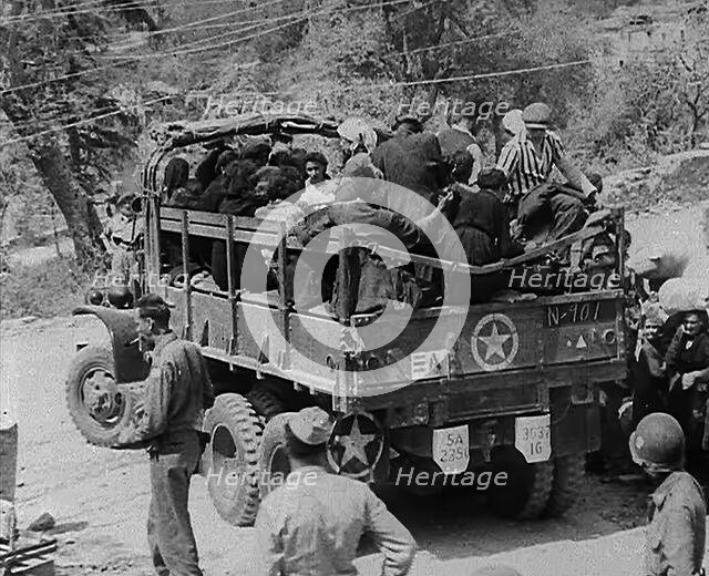 Italian Civilians Being Driven off in a US Army Truck, 1943-1944. Creator: British Pathe Ltd.