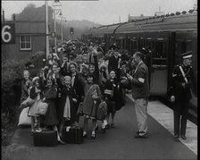 British Male and Female Evacuees on the Platform of a Small Station in the British Country..., 1939. Creator: British Pathe Ltd.