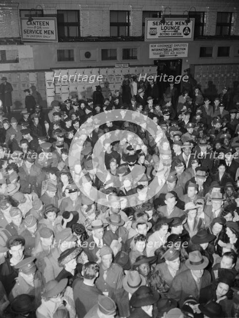 Crowds of soldiers, sailors, and civilians waiting to board trains at..., Washington, D.C., 1942. Creator: Gordon Parks.