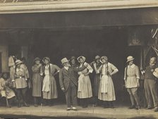 Sailors, some in drag, stand on stage performing a scene, (between 1910 and 1919?). Creator: Unknown.