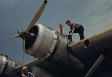 Fueling a plane at the Naval Air Base, Corpus Christi, Texas, 1942. Creator: Howard Hollem.