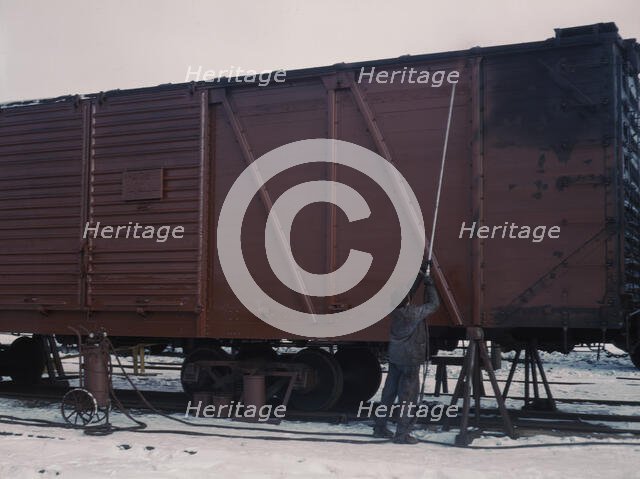 Painting a car at the repair or "rip" tracks at North Proviso(?), C & NW RR, Chicago, Ill., 1942. Creator: Jack Delano.