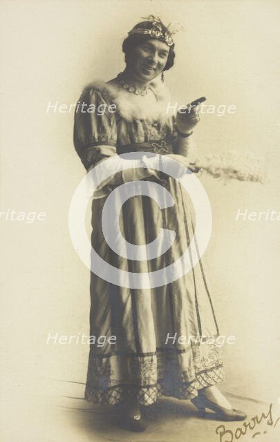 A man in drag, holding a feather, performing in the play 'A country girl', 1920. Creator: Unknown.