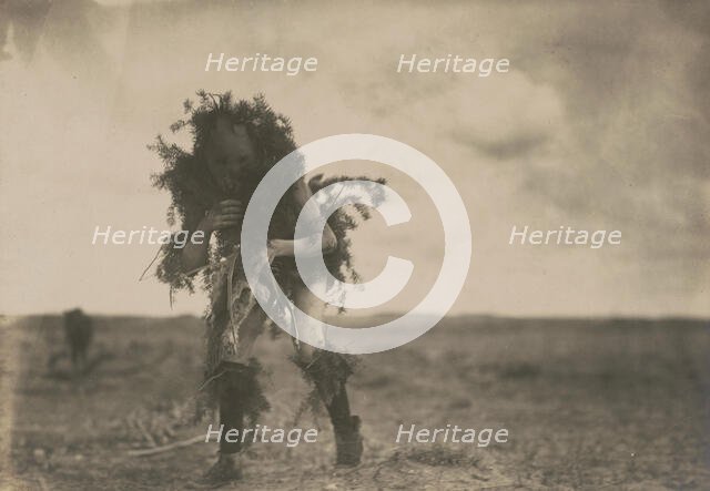 Yeibichai, the beggar, Tonenili-Navajo Indian, dressed in spruce branches, 1904, c1905. Creator: Edward Sheriff Curtis.