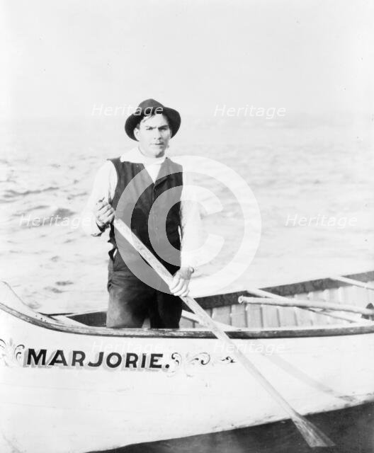 Indian guide for the rapids, standing in canoe, in the Sault Sainte Marie region of Michigan, 1903. Creator: Frances Benjamin Johnston.