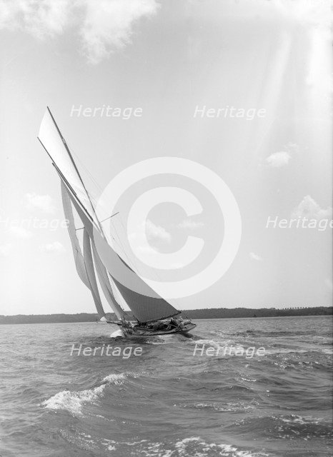 A 15 Metre yacht sailing close-hauled in a good breeze, 1911. Creator: Kirk & Sons of Cowes.