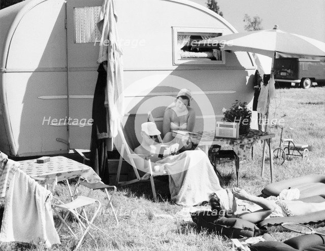 A couple by their caravan at the campsite, Trelleborg, Sweden, 1950s. Artist: Unknown