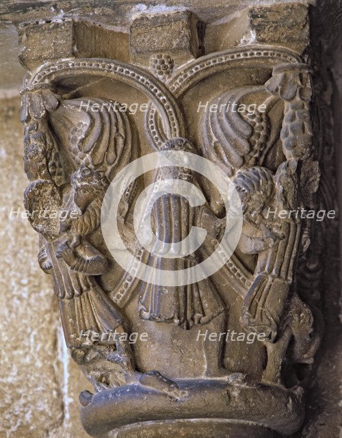 Capital decorated with the Good Shepherd with two figures on each side carrying a lamb and wolves…