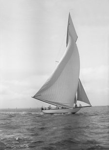 The 15-metre cutter 'Ostara' sailing downwind, 1911. Creator: Kirk & Sons of Cowes.