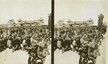 A crowd of Japanese soldiers; Chinese coolies in right foreground, Manchuria, c1905. Creator: Underwood & Underwood.