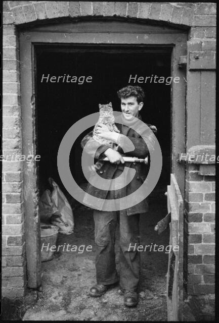 Miller holding a cat, Henley Mill, Henley, Bitterley, Shropshire, 1960-1968. Creator: Rex Wailes.