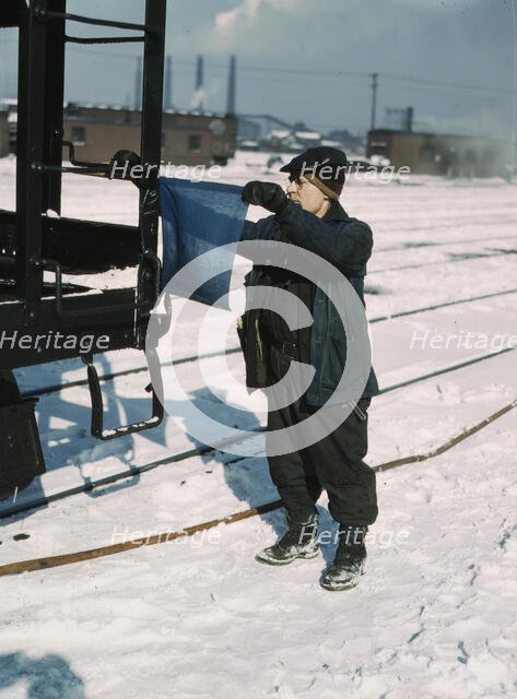 John Paulinski, car inspector, blue flagging a train for inspection, Corwith yard, Chicago, 1943. Creator: Jack Delano.