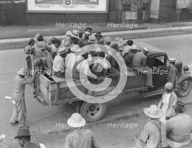 Cotton hoers are transported to the fields daily during the season, Memphis, Tennessee, 1937. Creator: Dorothea Lange.