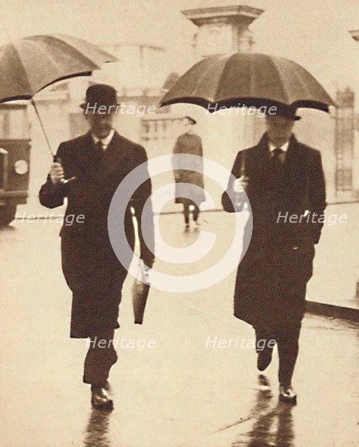 'Walking In The Rain', 1937. Artist: Unknown.