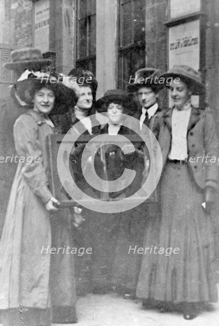 Five suffragettes holding a broken window in its frame, 1912. Artist: Unknown