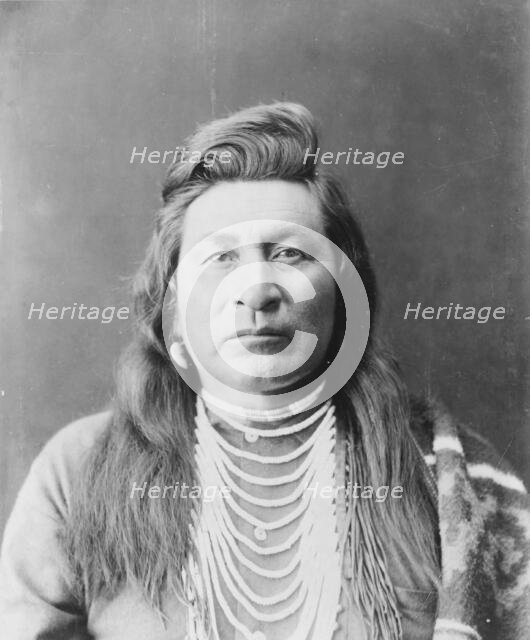 Nez Percé man, head-and-shoulders portrait, facing front, wearing bead necklace..., c1899. Creator: Edward Sheriff Curtis.