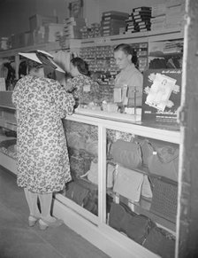 Shopper in a store at 7th Street and Florida Avenue, N.W., Washington, D.C., 1942. Creator: Gordon Parks.