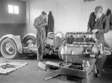 Mechanics working on Raymond Mays' 4500 cc Invicta car. Artist: Bill Brunell.