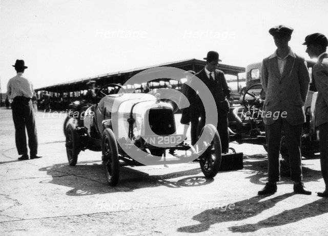 Malcolm Campbell and a Talbot car in the Paddock at Brooklands, Surrey, June 1923. Artist: Unknown